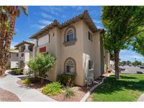 Two-story condo featuring desert landscaping, a walkway, and a neutral-toned stucco exterior at 3420 Winterhaven St # 202, Las Vegas, NV 89108