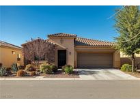 Charming single-story home with a tile roof, landscaped front yard, and two-car garage at 4780 Lorenzo Way, Pahrump, NV 89061