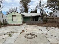 Modest home in disrepair featuring a large, cracked driveway in front and a dilapidated roof at 524 5Th St, Boulder City, NV 89005