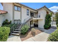 Two-story condo with stairs, small patio and desert landscaping provides curb appeal at 6735 W Charleston Blvd # 4, Las Vegas, NV 89146