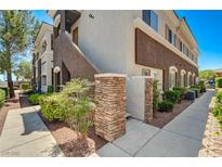 Inviting condo exterior featuring stone accents and well-maintained landscaping at 9303 Gilcrease Ave # 2217, Las Vegas, NV 89149