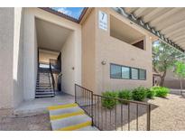 Exterior of a two-story residential building showing the entrance and stairs to the second floor units at 2451 N Rainbow Blvd # 2043, Las Vegas, NV 89108