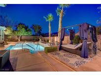 Inviting backyard pool with a luxury lounge area and lush landscaping for relaxing evenings at 4624 Leon De Oro Dr, Las Vegas, NV 89129