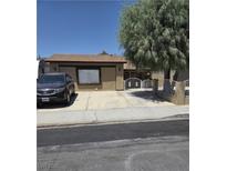 Charming single-story home with a well-maintained front yard, secure driveway gate, and mature tree at 520 Prince Alan Ct, Las Vegas, NV 89110