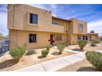 Two-story tan home with desert landscaping in the front yard at 5706 W Lake Mead Blvd, Las Vegas, NV 89108