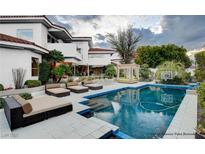 Inviting backyard boasts a sparkling pool, cabana, and multiple lounge areas for relaxing and entertaining at 60 Innisbrook Ave, Las Vegas, NV 89113