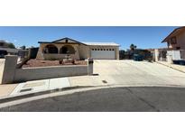 Charming single-story home featuring an arched front porch and a spacious driveway leading to a two-car garage at 7116 Bramble Ct, Las Vegas, NV 89145