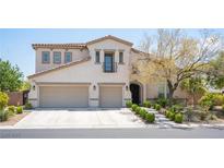 Charming two-story home with stucco exterior, two-car garage, and manicured front yard landscaping at 7538 Mustang St, Las Vegas, NV 89131