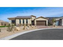 Stylish single-story home featuring desert landscaping, a brown metal roof, and brick-paved driveway at 796 Windover Ct, Las Vegas, NV 89138
