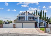 Charming two-story home with blue siding, black shutters, solar panels, and well-manicured lawn at 9436 Darwell Dr, Las Vegas, NV 89117