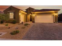 Charming single-story home with desert landscaping, brick driveway, and spacious three-car garage at 977 Majestic Vw, Mesquite, NV 89034