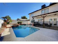 Inviting backyard pool and spa with concrete decking and covered patio, perfect for outdoor entertaining at , Henderson, NV 89014