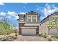 Charming two-story home with stone accents and a brick driveway at 10345 Zebra Swallowtail St, Las Vegas, NV 89141