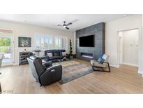 Inviting living room with sleek fireplace feature wall, stylish furniture, and light-filled windows at 10504 Button Willow Dr, Las Vegas, NV 89134