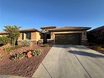 Charming single-story home featuring a desert landscape, a two-car garage, and a stone-accented facade at 10507 Oak Terrace Ave, Las Vegas, NV 89149