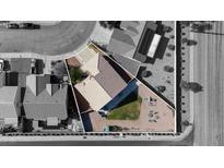 A high-angle view of a cozy single-Gathering home featuring a low-maintenance backyard and desert landscaping at 1079 Oak Shade Ln, Henderson, NV 89015