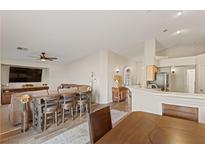 Open-concept living room featuring a breakfast bar, comfortable seating, and modern finishes at 1079 Oak Shade Ln, Henderson, NV 89015