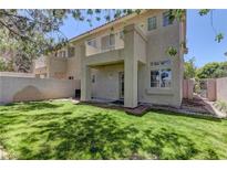 Lush backyard featuring a well-maintained lawn, brick accents, and a charming covered patio, perfect for outdoor relaxation at 108 Broken Rock Dr, Henderson, NV 89074