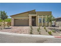 Inviting single story home with desert landscaping, brick driveway, and a two-car garage at 12438 Heritage Bend Dr, Las Vegas, NV 89138