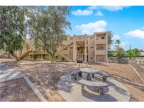 Inviting condo exterior showcasing communal seating area and convenient access to units via exterior stairwells at 2007 Cutlass Dr # 0, Henderson, NV 89014