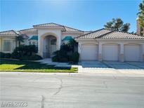Elegant single-story home with a three-car garage and well-manicured front yard at 2017 Eagle Trace Way, Las Vegas, NV 89117