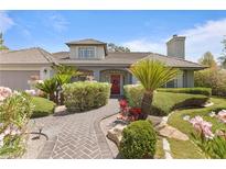 Charming single-story home with beautifully landscaped front yard and inviting brick walkway at 2222 Lucerne Ct, Henderson, NV 89014