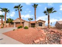 Charming single-story home featuring desert landscaping and mature palm trees on a sunny day at 3157 Faiss Dr, Las Vegas, NV 89134