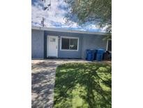 Cozy single-story home with a well-maintained lawn and blue exterior paint at 324 Princeton St, Las Vegas, NV 89107