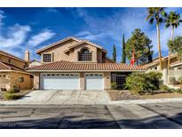 Charming two-story home with a red tile roof, three-car garage, and desert landscaping at 3355 Royal Bay Dr, Las Vegas, NV 89117