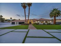 Expansive home with well manicured lawn, tiled entryway, desert landscaping, and attached garage at 3630 Tobias Ln, Las Vegas, NV 89120