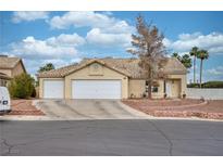 Charming single-story home featuring a three-car garage, low maintenance landscape, and a tile roof at 4878 Califa Dr, Las Vegas, NV 89122