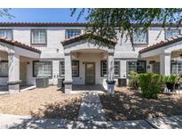Charming townhome featuring a quaint front porch and well-maintained gravel landscaping for added curb appeal at 5330 E Charleston Blvd # 2, Las Vegas, NV 89142