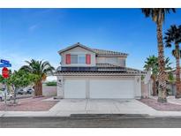 Two-story home featuring a three-car garage, solar panels, and desert landscaping, perfect for Las Vegas living at 5823 Rose Sage St, North Las Vegas, NV 89031