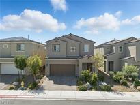 Charming two-story home featuring a brick-paved driveway and beautifully landscaped front yard at 6322 Angora Peak Ln, Las Vegas, NV 89115
