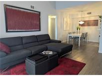 Bright living room featuring a comfortable sectional couch, dining area, and stylish decor at 6650 W Warm Springs Rd # 2159, Las Vegas, NV 89118