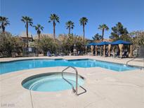Community pool and spa with lounge seating and shaded cabanas in a tropical setting with palm trees at 6650 W Warm Springs Rd # 2159, Las Vegas, NV 89118