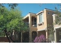 Charming two-story home featuring stucco siding, balcony, and desert landscaping at 6927 Smiling Cloud Ave, Henderson, NV 89011