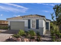 Charming single-story home with a tiled roof, gray siding, and landscaped front yard, showcasing curb appeal at 739 Wild Highlands Ln, Henderson, NV 89015