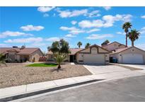 Charming single-story home featuring a well-maintained gravel yard, mature trees and an attached two-car garage at 8000 Vista Twilight Dr, Las Vegas, NV 89123