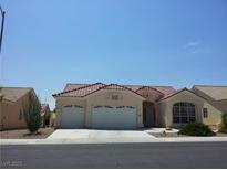 Charming single-story home with a two-car garage and a well-maintained front yard landscape at 8545 Summer Vista Ave, Las Vegas, NV 89145