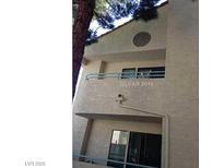 A clean, two-story condo with stucco siding and private balconies on each level at 910 N Sloan Ln # 201, Las Vegas, NV 89110