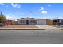 Charming single-story home with neutral desert landscaping, and a well-maintained exterior at 1115 W Nelson Ave, North Las Vegas, NV 89030
