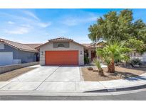 Charming single-story home with a desert-landscaped front yard and an attached two-car garage at 1225 Stonesthrow Cir, North Las Vegas, NV 89031