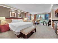 Comfortable suite featuring a king-size bed, city views, and a kitchenette at 135 E Harmon Ave # 315, Las Vegas, NV 89109