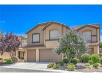 Charming two-story home with tile roof, two-car garage, and professionally landscaped yard at 2189 De Narvik Dr, Henderson, NV 89044