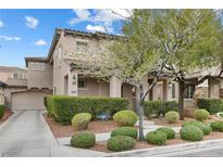 Charming two-story home featuring a well-manicured front yard and a covered porch entry at 2231 Desert Prairie St, Las Vegas, NV 89135