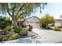Charming single-story home featuring mature landscaping and a two-car garage at 2326 Garnet Star St, Henderson, NV 89044