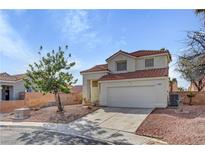 Charming two-story home featuring a red tile roof, a well-maintained yard, and an attached two-car garage at 2573 Rafferty Creek Ln, Las Vegas, NV 89156