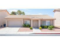 Charming single-story home with a tile roof, low-maintenance landscaping, and an attached two-car garage at 2859 Palleta Dr, Henderson, NV 89074