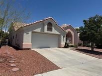 Charming single-Gathering home featuring a two-car garage, desert landscaping, and a classic tile roof in a sunny setting at 2904 Channel Bay Dr, Las Vegas, NV 89128